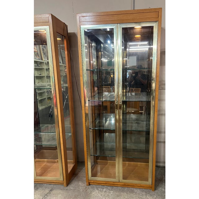 Brass glass display cabinet or vitrines style of Mastercraft. These chic and elegant cabinet are in very good condition...