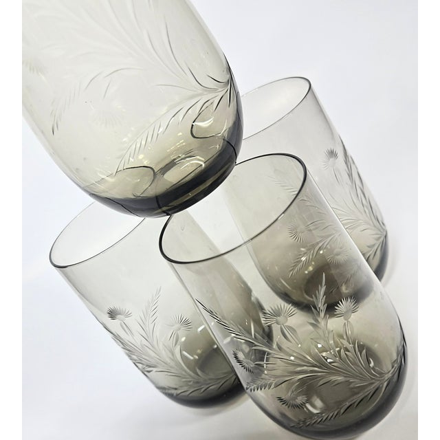 Hit the pictures, my words are nothing. Just unbelievable. This is an intricately handcarved design on a smoky crystal...