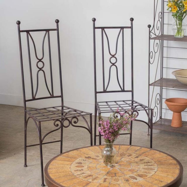 Lovely vintage set of 6 iron outdoor dining chairs from France. Beautiful Neoclassical style scroll iron design with ball...