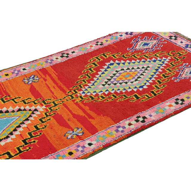 Hand-knotted in wool and originating from Morocco circa 1950-1960, this 3x7 vintage Moroccan rug is an extremely rare...