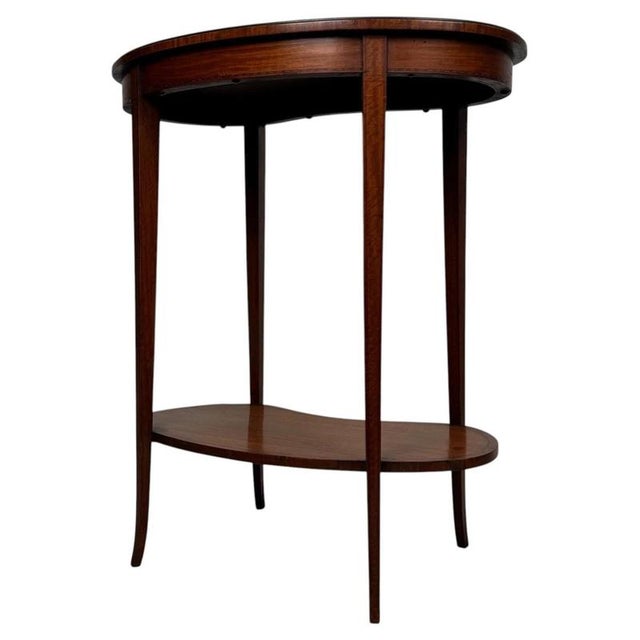 An elegant and unusual 19th-century English kidney-shaped side table, finely crafted from satinwood and distinguished by...