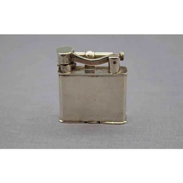 Sterling silver lighter, Mexico, circa 1940-50s. Marked "Silver Sterling", "Made in Mexico". Engraved with an Aztec...