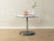 Postmodern side table from the 1980s. Chrome-plated metal frame with a glass tabletop and a metal base. Quality features:...