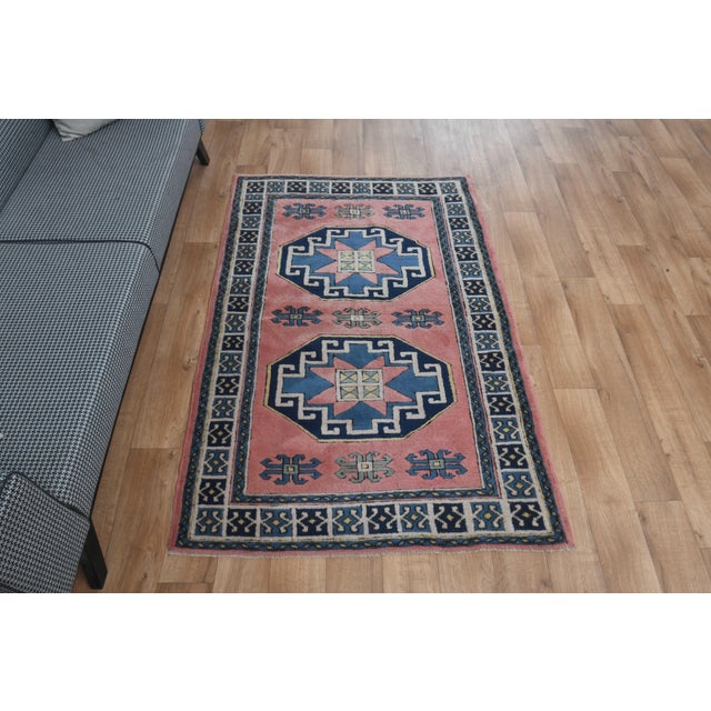 Vintage Hand-Knotted runner rug is a semi-antique vintage area rug. The '70s Eastern region of Anatolia's unique rug is...