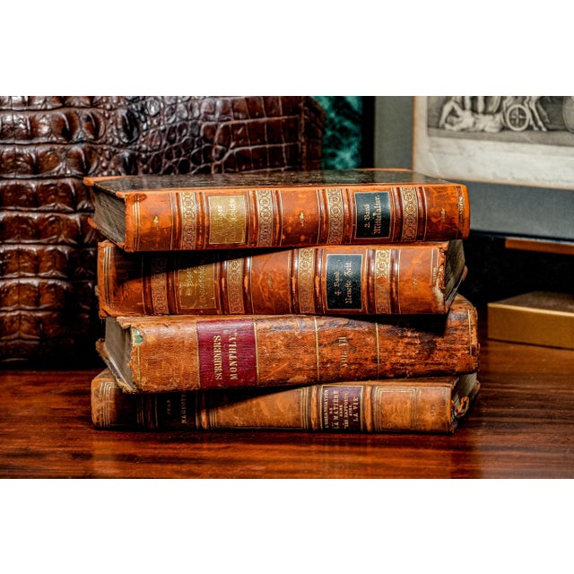 This collection of four antique leather spine books offers a glimpse into the rich history of literature and...