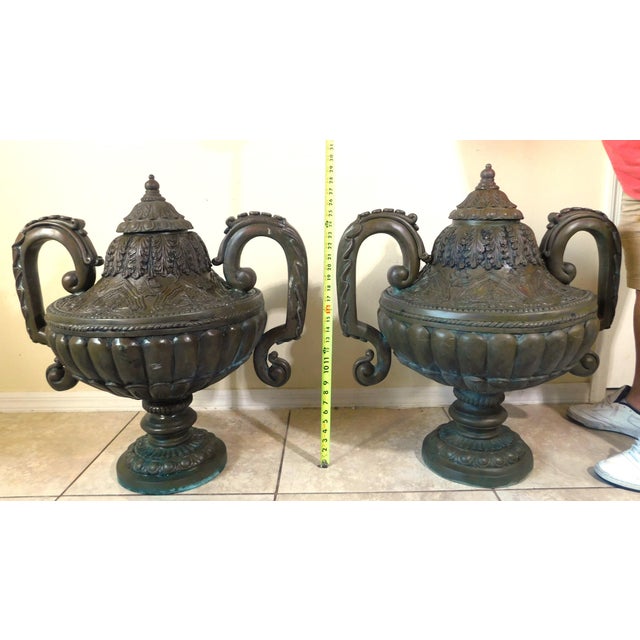Fabulous pair of large antique bronze garden urn statues. Large handles and a removable lid. Very heavy bronze (approx. 50...
