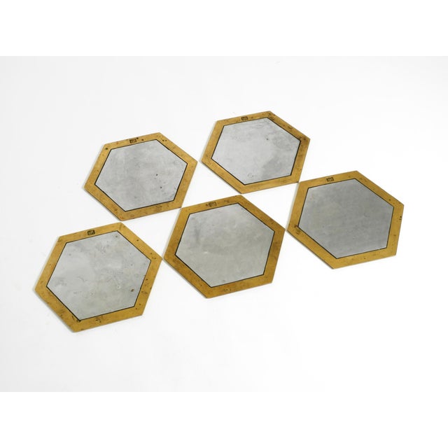 Five rare, heavy, large coasters in a brutalist design, made of aluminum and brass by David Marshall. Made in Spain....