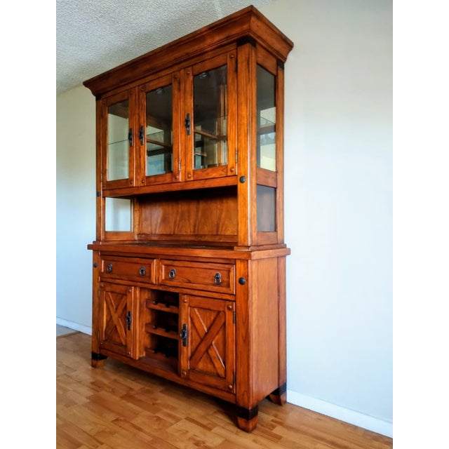 This storage cabinet features an illuminated upper display section with glass on all sides and two doors. The central...