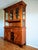 This storage cabinet features an illuminated upper display section with glass on all sides and two doors. The central...