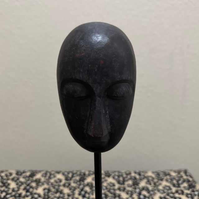 This piece is a striking African-style carved wood head sculpture, a common motif in both traditional tribal art and mid-...