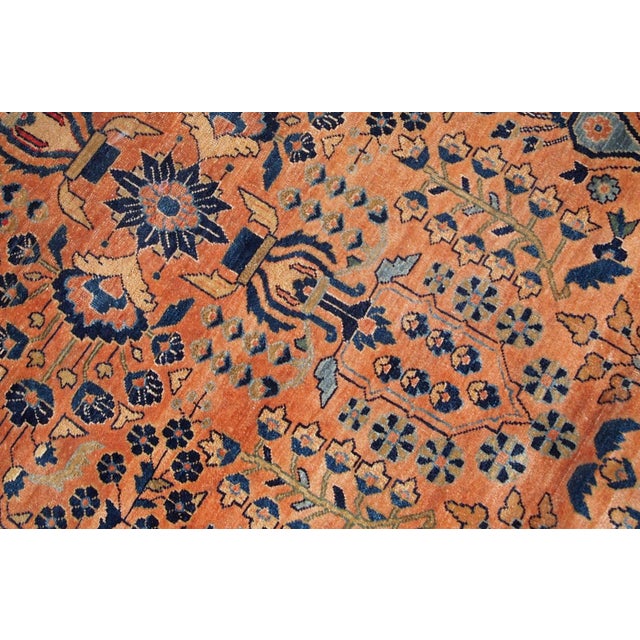 Handmade antique Sarouk rug in original good condition. The rug has been made in the beginning of 20th century in red...