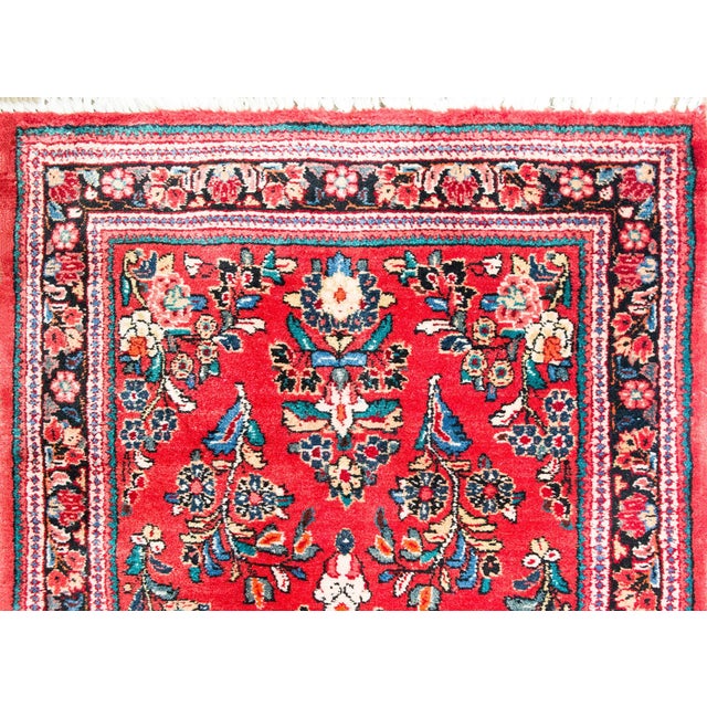 A traditional early 20th century Persian Sarouk runner with an all-over mirrored float pattern woven in varying shades of...