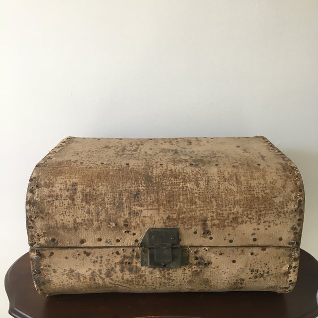 A late 19th century small storage chest constructed of wood and wrapped in a vellum-like material, with an exceptionally...
