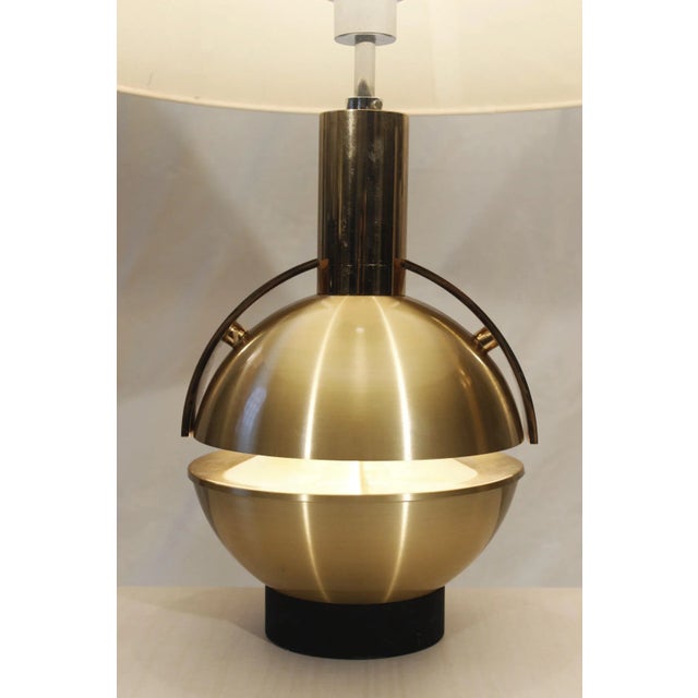 Lamp circa 1970 forming an open sphere in gilded aluminium with double lighting. European Plug (up to 250V).The wiring of...