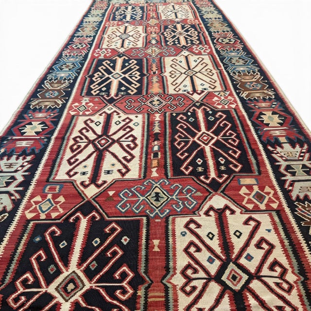 This rare antique Avar kilim runner, approximately 120 years old, is a powerful example of tribal design transformed...