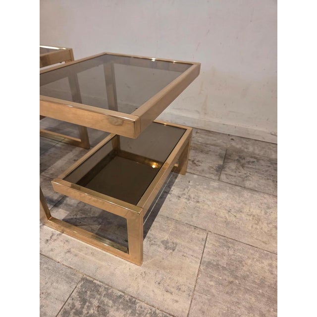 A striking pair of Mid-Century Modern side tables by Belgo Chrome, distinguished by their sculptural silhouette and...