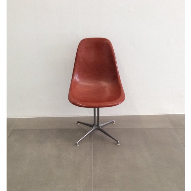 The chair features an embossed Herman Miller logo. The armchairs have the logo on the rubber pads under the seat, as shown...