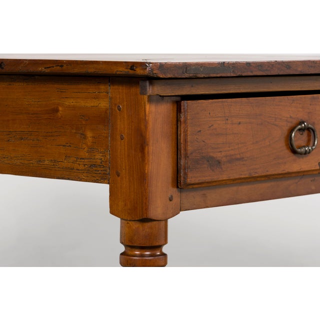 Sourced in Provence, France, this late 19th century French provincial fruitwood table reflects a restrained, functional...