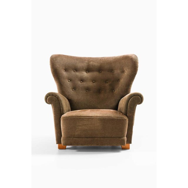 This rare and generously scaled easy chair, attributed to swedish designer elias svedberg, reflects the confident, human-...