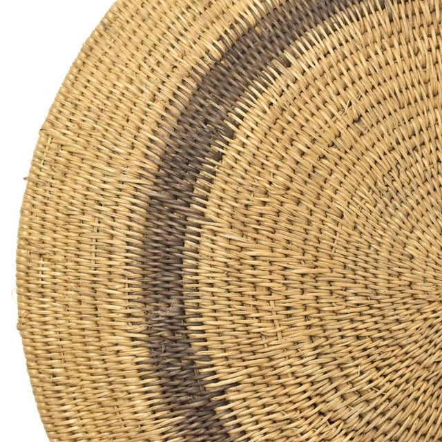Handwoven Makenge flat wedding basket handmade by the Mbundu women within Zambia. These baskets are traditionally made...