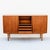 Vintage mid century teak highboard / sideboard in beautifully preserved condition, made in Denmark c. 1960s. With sculpted...