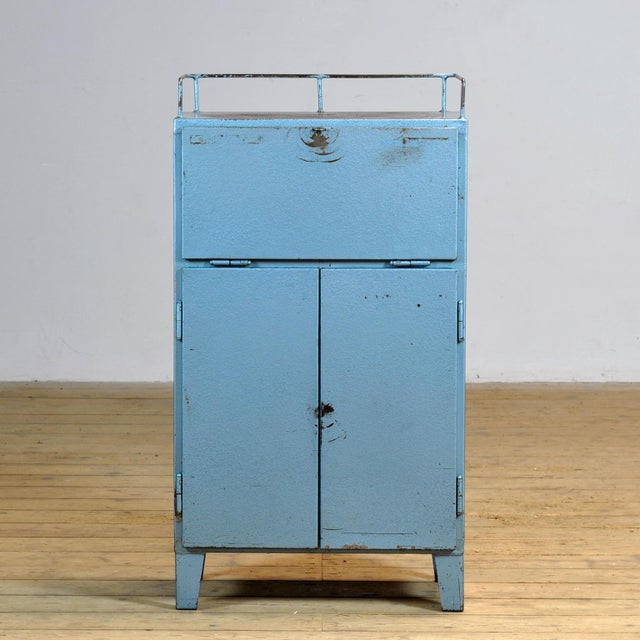 Bring a touch of vintage industry to your interior with this robust 1970s cabinet. Made of iron and finished in a blue hue...