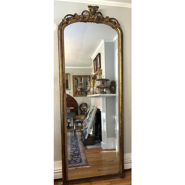 . A stunning Louis-XV style (Rocaille) revival mirror circa 1850–1880 with hand-carved giltwood and a finely scrolled,...