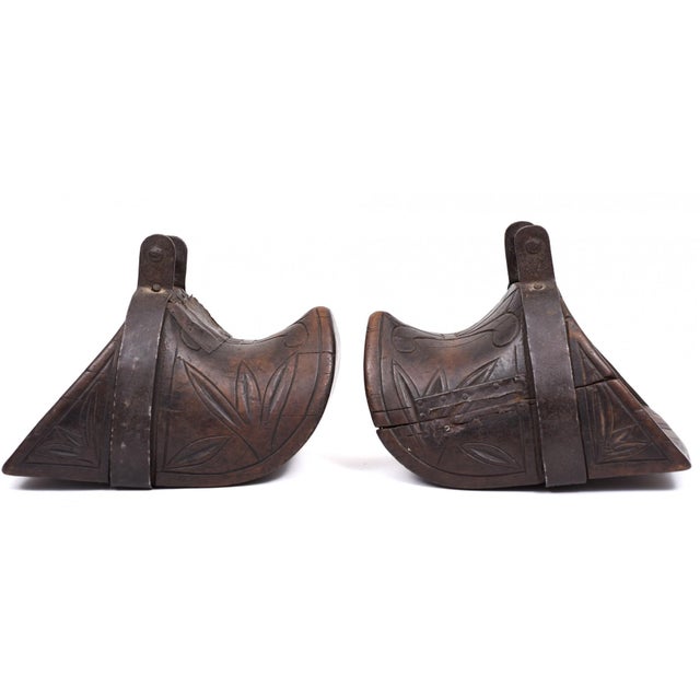 A pair of antique South American carved wooden stirrups, known as estribos, carved from a single block of wood and...
