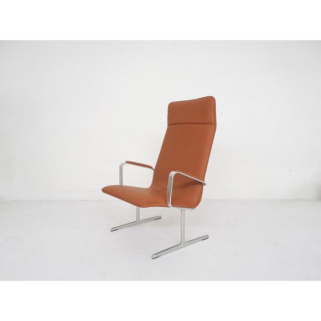 Very rare lounge chair designed by Dieter Rams for Vitsoe. The chair has been reupholstered in cognac faux-leather. The...