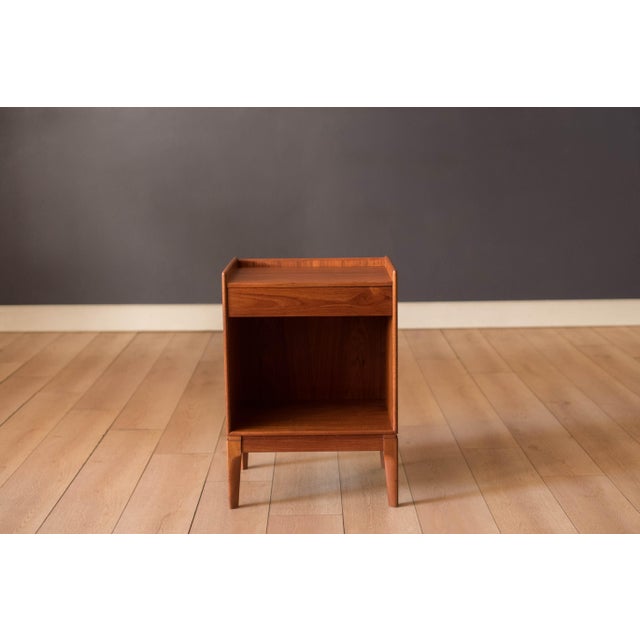 Mid Century Modern bedside table nightstand manufactured by Soborg Mobler, circa 1960s. This unique piece is made of teak...