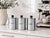 Set of three French chrome canisters labeled Sucre, Café, and Chicorée with black knobs. A classic midcentury kitchen set,...