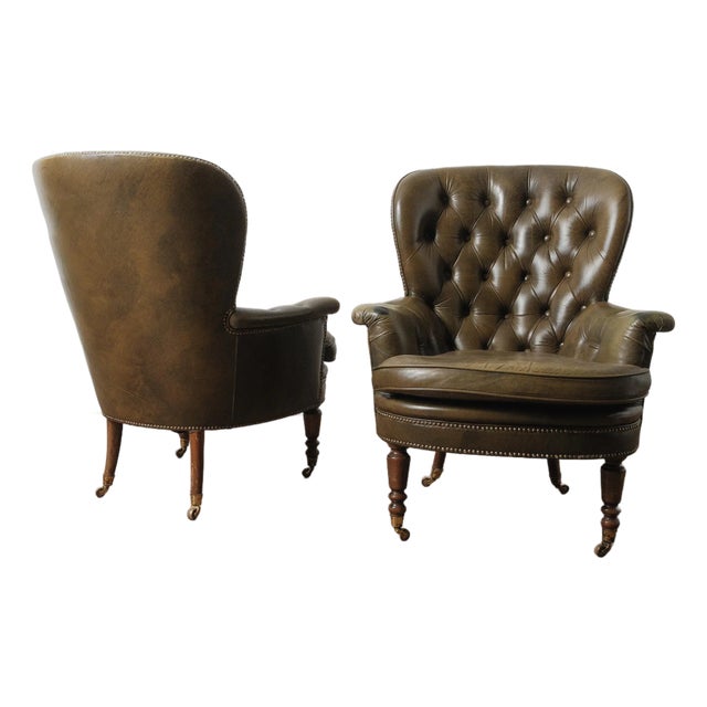 Pair of Vintage Tufted Leather Club Chairs With Brass Casters and Turned Legs For Sale