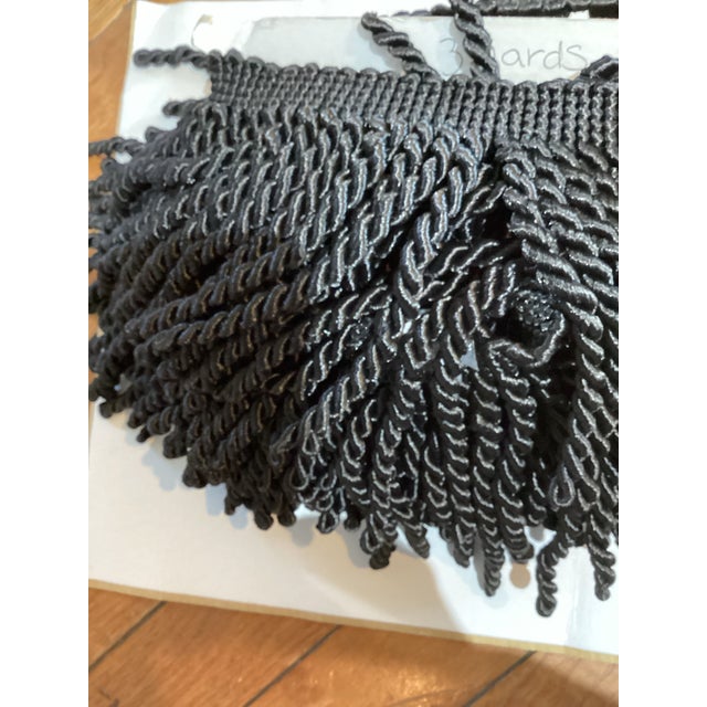One inch border with four inch twisted fringe in black. Three yard piece.