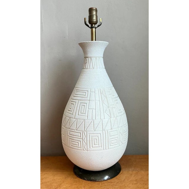 This mid-century modern table lamp features a sculptural, gourd-shaped ceramic body finished in a matte, lightly stippled...