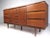 This Mid-Century Modern walnut dresser features nine spacious drawers for bedroom storage, tapered legs and unique drawer...