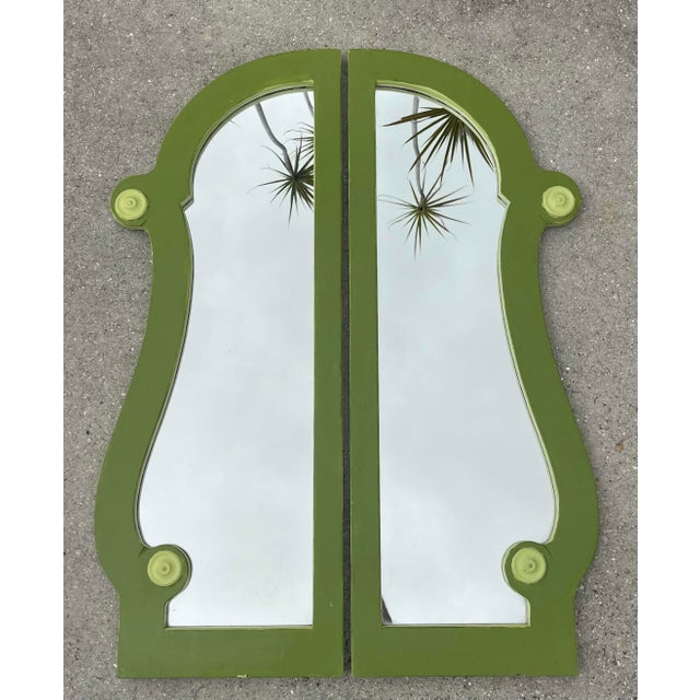Striking pair of vintage architectural wall mirrors finished in a richly layered olive green paint with sculptural...