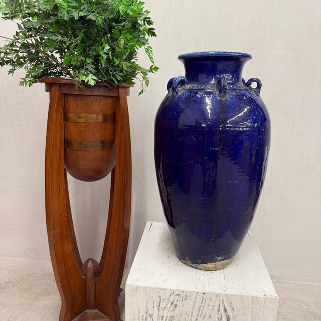 "About This Piece About This Piece This tall earthenware jar captures attention with its mesmerizing cobalt glaze, a hue...