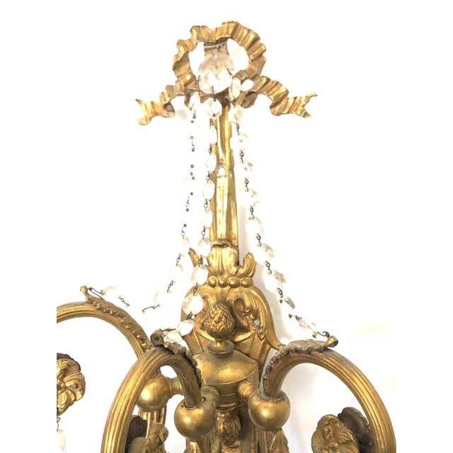 Stunning Pair of Louis XV Three arm unlacquered solid brass sconces with detailed scrollwork, elegant swags, and faceted...