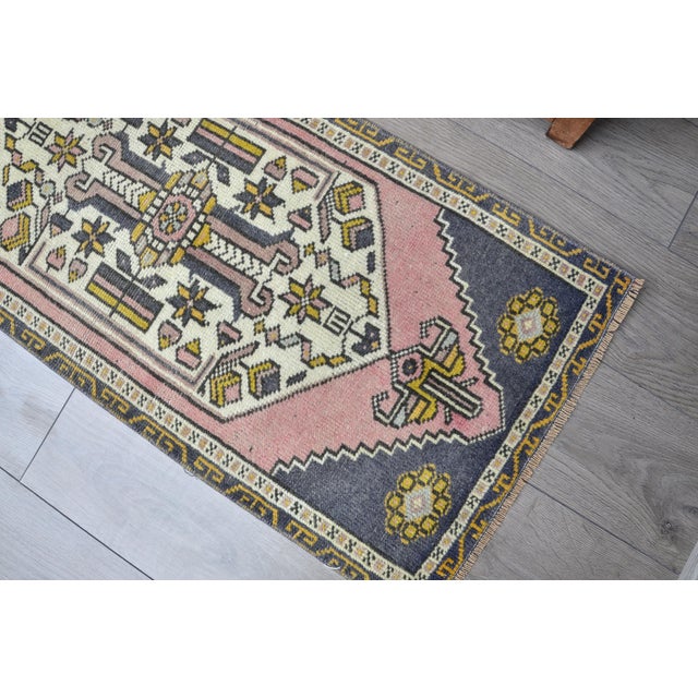 This is a vintage Turkish Oushak rug from the 1960s. The piece was hand-knotted.