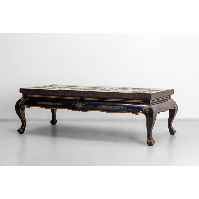 A remarkable chinoiserie coffee table of french manufacture, dating from the 1950s, blending lacquerwork, hardstone inlay...