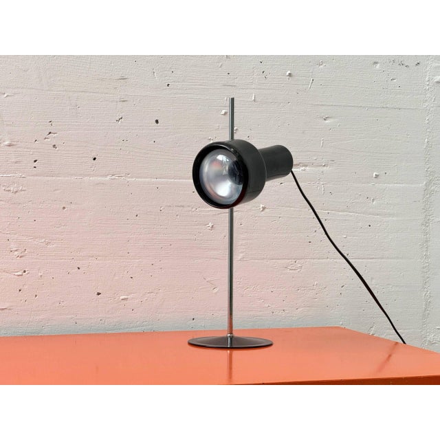 This table lamp from france, dating from the 1970s, exhibits a clearly functional, technically influenced design language...