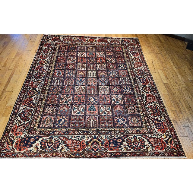 A near square vintage Persian Bakhtiari rug, handwoven in the second quarter of the 20th century and showcasing the highly...