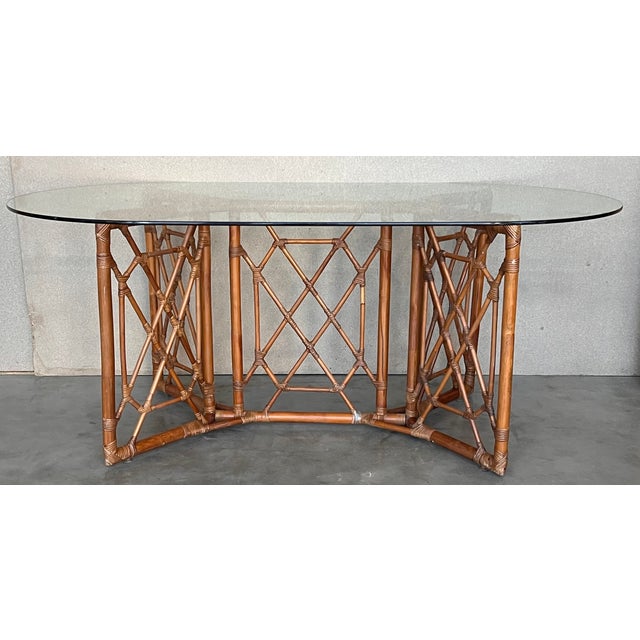 Impressive mid-century table crafted in bamboo and bent bamboo . Complete with a glass top. Dimensions: Height: 29.34 in...