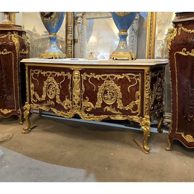 A true masterpiece of French-inspired luxury, this stunning Louis XV Bombe Commode showcases an elegant serpentine...