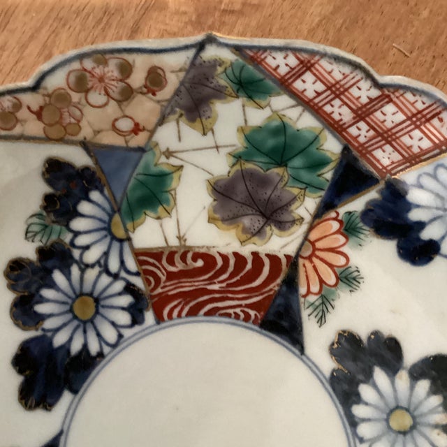 The Antique Arita Porcelain Hand Painted Imari Bowl from the Meiji Period (1868-1912) in Japan is an exquisite piece of...