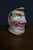 French ceramic character pitcher by Sarreguemines, featuring a sculpted male face with exaggerated features, rosy cheeks,...