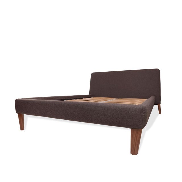 The Design Within Reach Full Size Parallel Bed Frame, offered new in box, showcases a clean, architectural profile with...