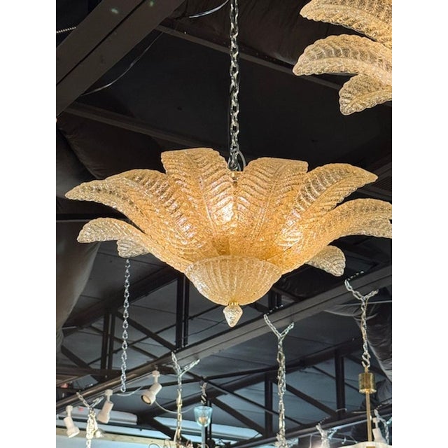 The Pair of Murano Amber Granola Palm Leaf Flush Mount Chandeliers is a stunning addition to any home. These chandeliers...