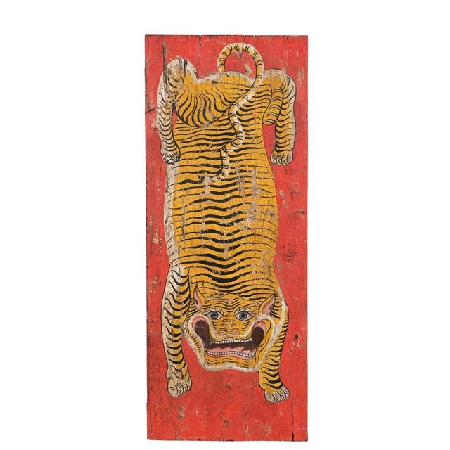 This Vintage Indian Painted Panel is a striking work of folk art featuring a boldly rendered Tibetan style tiger set...