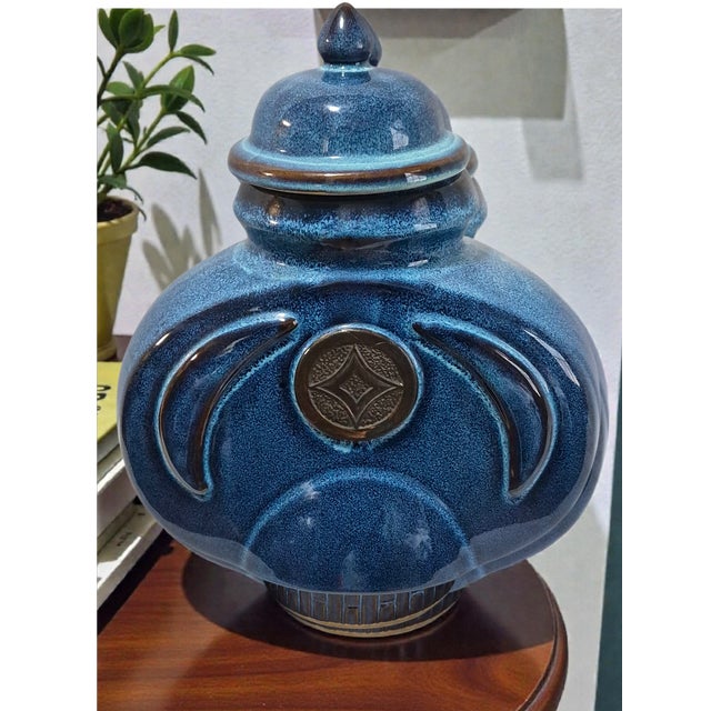 This Asian Chinoiserie Blue Pottery Lidded Ginger Jar is a stunning piece featuring intricate medallion center decoration,...